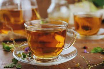 Hot herbal tea with chamomile and honey on wooden background 