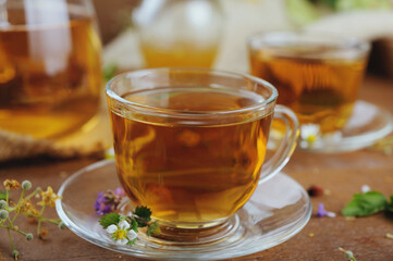 Hot herbal tea with chamomile and honey on wooden background 