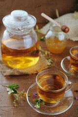 Hot herbal tea with chamomile and honey on wooden background 