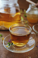 Hot herbal tea with chamomile and honey on wooden background 
