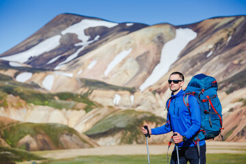 hiker with backpack enjoying the landscape of Iceland while hiking the Laugavegur trail