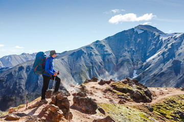 Obraz premium hiker with backpack enjoying the landscape of Iceland while hiking the Laugavegur trail