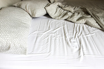 Fototapeta na wymiar Mattress, blanket and pillows after waking up.