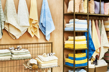 Colored terry towels on a shelf - obrazy, fototapety, plakaty