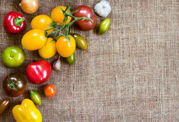 Assortment of colorful fresh vegetables on sackcloth background