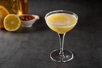 Luxury cocktail with lemon and tequila on a dark stone background