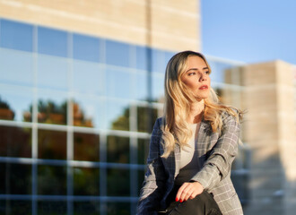 Beautiful business woman sitting on a bench in the financial city.