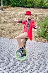 Male performer riding unicycle in park © JoseIMartin