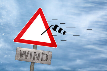 Wind warning sign getting blown away by a storm