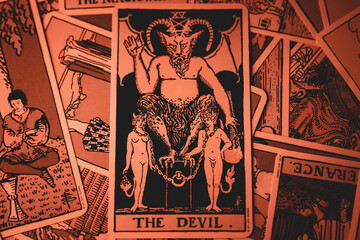 Devil tarot card in creepy dark orange light