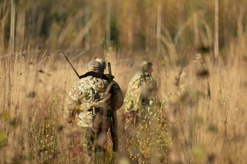 Group of hunters during hunting in the forest