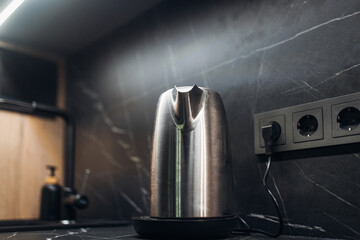 Metal electric kettle in modern kitchen
