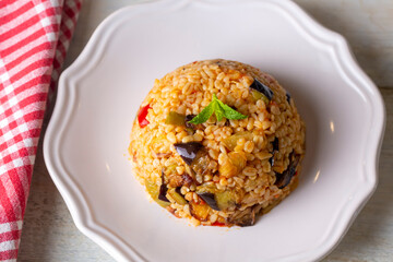 Traditional delicious Turkish food; Bulgur pilaf with eggplant and vegetables. (Turkish name; Patlicanli bulgur pilavi)