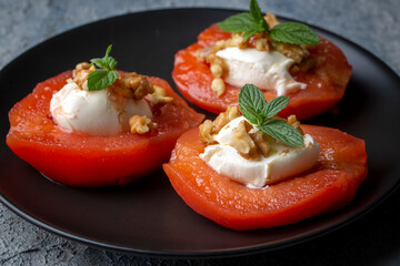 Traditional Turkish style quince dessert. The quince is cooked until soft, sherbet is poured on it, and served with cream and walnuts. It is one of the most popular Turkish desserts.(Ayva Tatlisi)