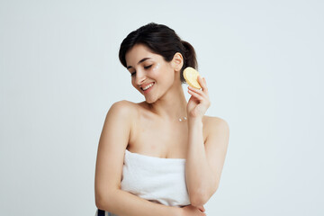 woman in towel apply cream to clean body health
