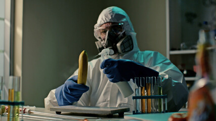 Scientist spraying banana with liquid examining dna test in lab