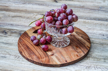 A handful of grapes in a glass cup