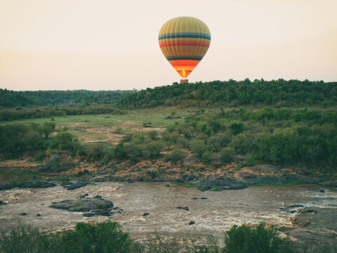 Vintage photography style of hot air Balloon for tourist in Maasai Mara National park, Kenya, selected focus.