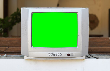 An old silvery green-screen TV for adding video sits in an abandoned hotel. Vintage TVs 1980s 1990s...