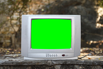 An old silvery green-screen TV for adding video sits in an abandoned hotel. Vintage TVs 1980s 1990s...