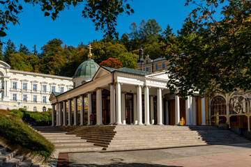 Fototapeta na wymiar Mariánské Lázně (Marienbad) - white columns pavilion of mineral water spring in autumn - main colonnade - Czech Republic