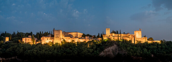 Extra-large panoramic photograph of the landscape of the monumental complex La Alhambra, blue sky
