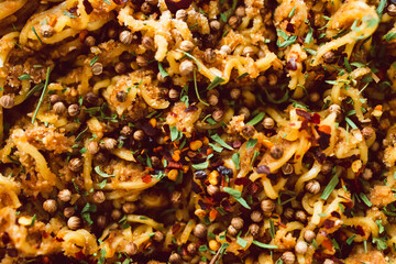 vegan ginger noodles with chilli flakes coriander seeds and tarragon herbs as topping, healthy plant-based food