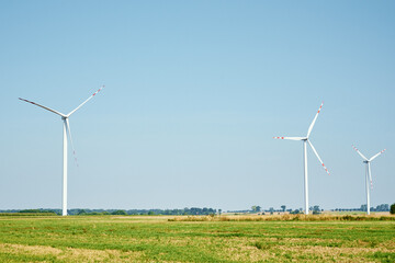 Renewable green energy concept. Windmills turbines in the field.