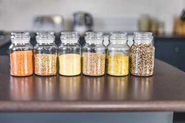 clear pantry jars with different types of grains and legumes including quinoa  lentils buckwheat...