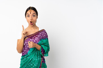Young indian woman isolated on white background intending to realizes the solution while lifting a...