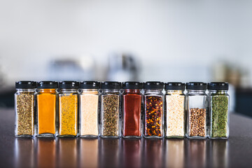spices seeds and seasonings in mathing spice jars on tidy pantry shelf, simple vegan ingredients...