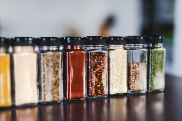 spices seeds and seasonings in mathing spice jars on tidy pantry shelf, simple vegan ingredients and flavoring your dishes