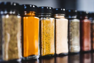 Keuken spatwand met foto spices seeds and seasonings in mathing spice jars on tidy pantry shelf, simple vegan ingredients and flavoring your dishes © faithie