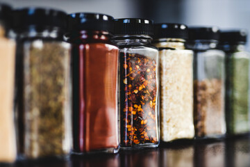 spices seeds and seasonings in mathing spice jars on tidy pantry shelf, simple vegan ingredients...