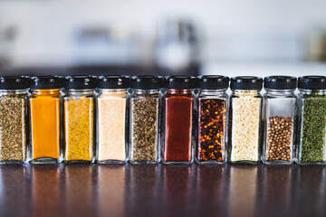 spices seeds and seasonings in mathing spice jars on tidy pantry shelf, simple vegan ingredients...