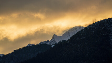 sunrise on the mountains with view of the snow capped alps at the golden hour