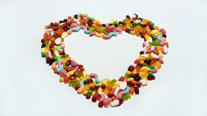 Many colorful sweets, jelly candies made from fruit juice, gelatin and sugar in the shape of heart isolated over white background