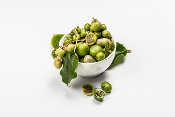 Ripe Actinidia arguta or kiwi in a bowl isolated on white background