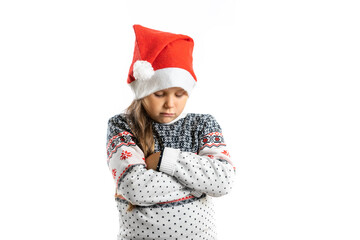 portrait of sad, offended, disappointed girl in white knitted Christmas sweater with reindeer, isolated on white background. 