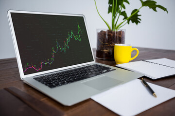 Laptop on desk with statistical data on screen