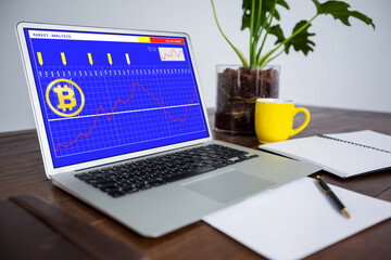Laptop on desk with statistical and financial data on screen