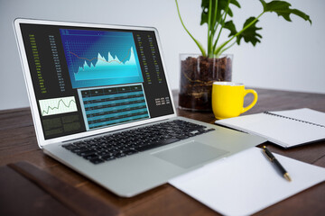 Laptop on desk with statistical data on screen