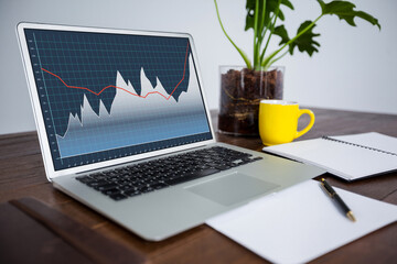 Laptop on desk with statistical data on screen