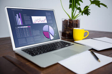 Laptop on desk with statistical data on screen