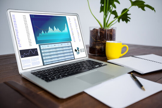 Laptop on desk with statistical data on screen