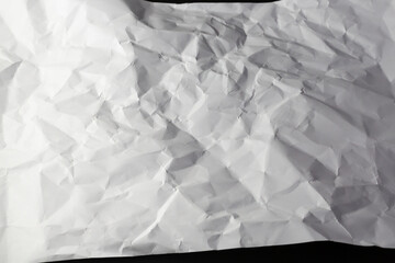 Close up of light and shadow on creases in sheet of white paper