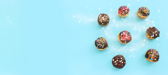 image of donuts over blue background. jewish holiday Hanukkah symbol