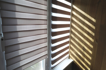 Shade from the blinds on the wall . Thin lines of light on the wall. The texture of the wood. Place for your text.