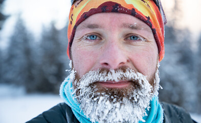 portrait of man face with frozen beard in harsh winter