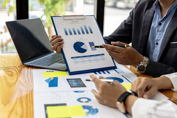 Executives and managers are meeting in a conference room, on the table there are some documents...